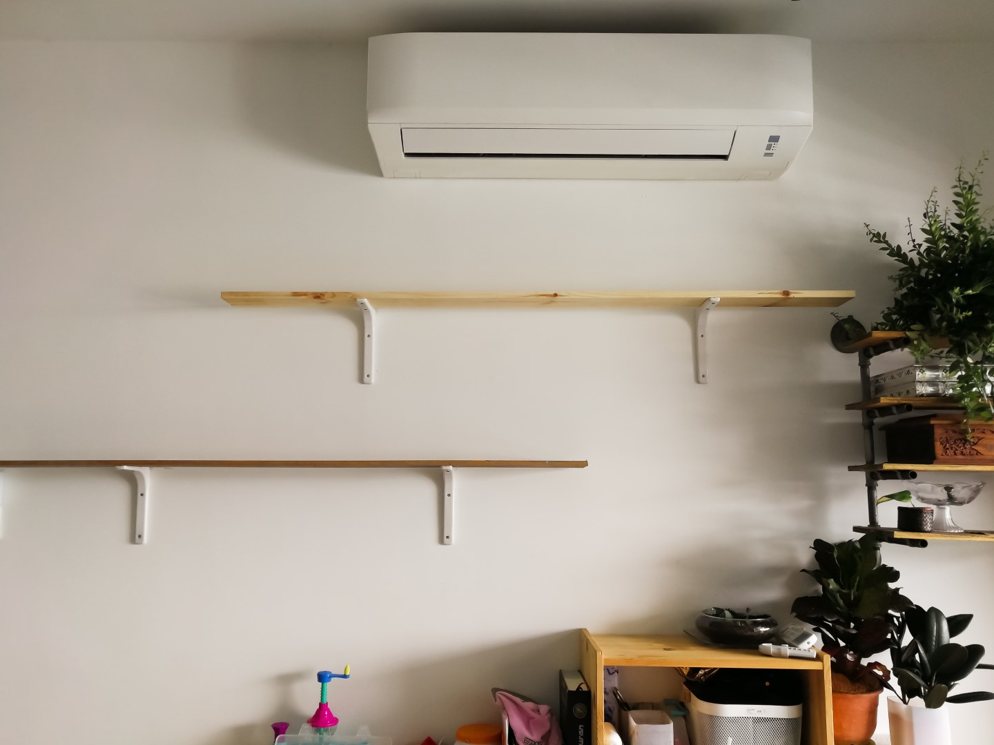 air conditioner and wooden shelves on a white wall 2026 03 20 06 15 56 utc Large
